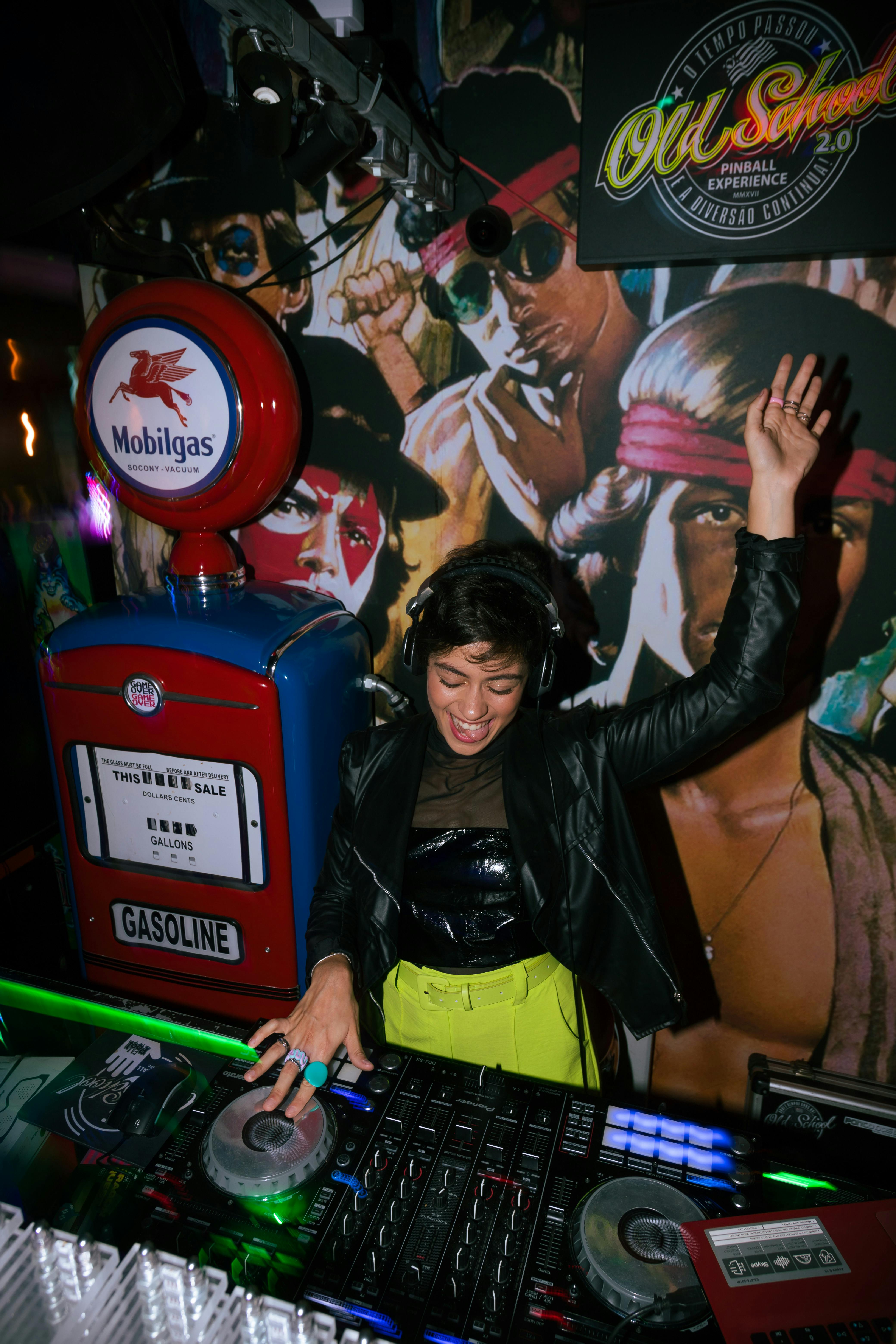 DJ energizing the crowd with vibrant music at a nightclub in a lively atmosphere.
