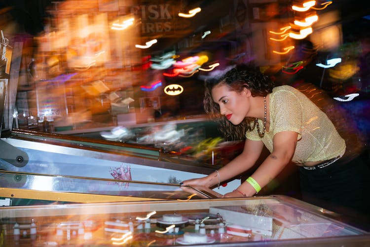 Woman Playing Game In Club At Night