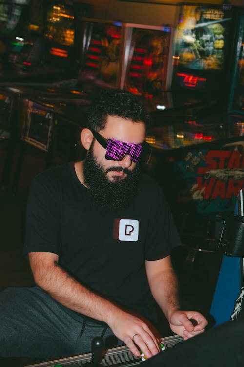 Man Playing a Video Game at an Arcade 