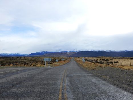 Empty rural road leading to Torres del Paine mountains. Perfect for travel and adventure themes.