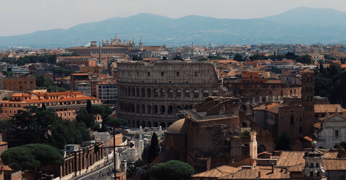 Colosseum among Buildings in Rome · Free Stock Photo