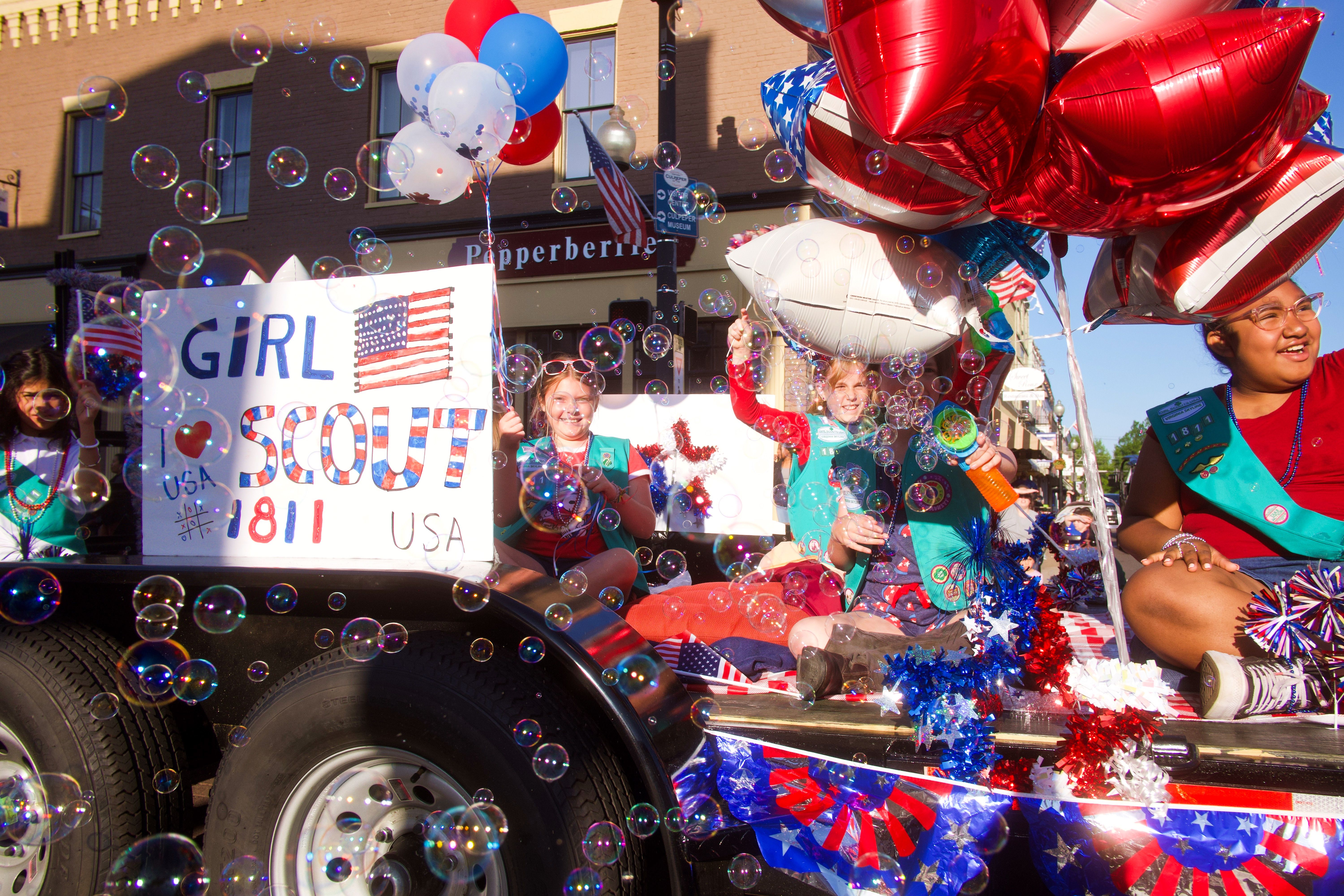 Girl Scouts Riding on the Back of a Truck at a Parade · Free Stock Photo