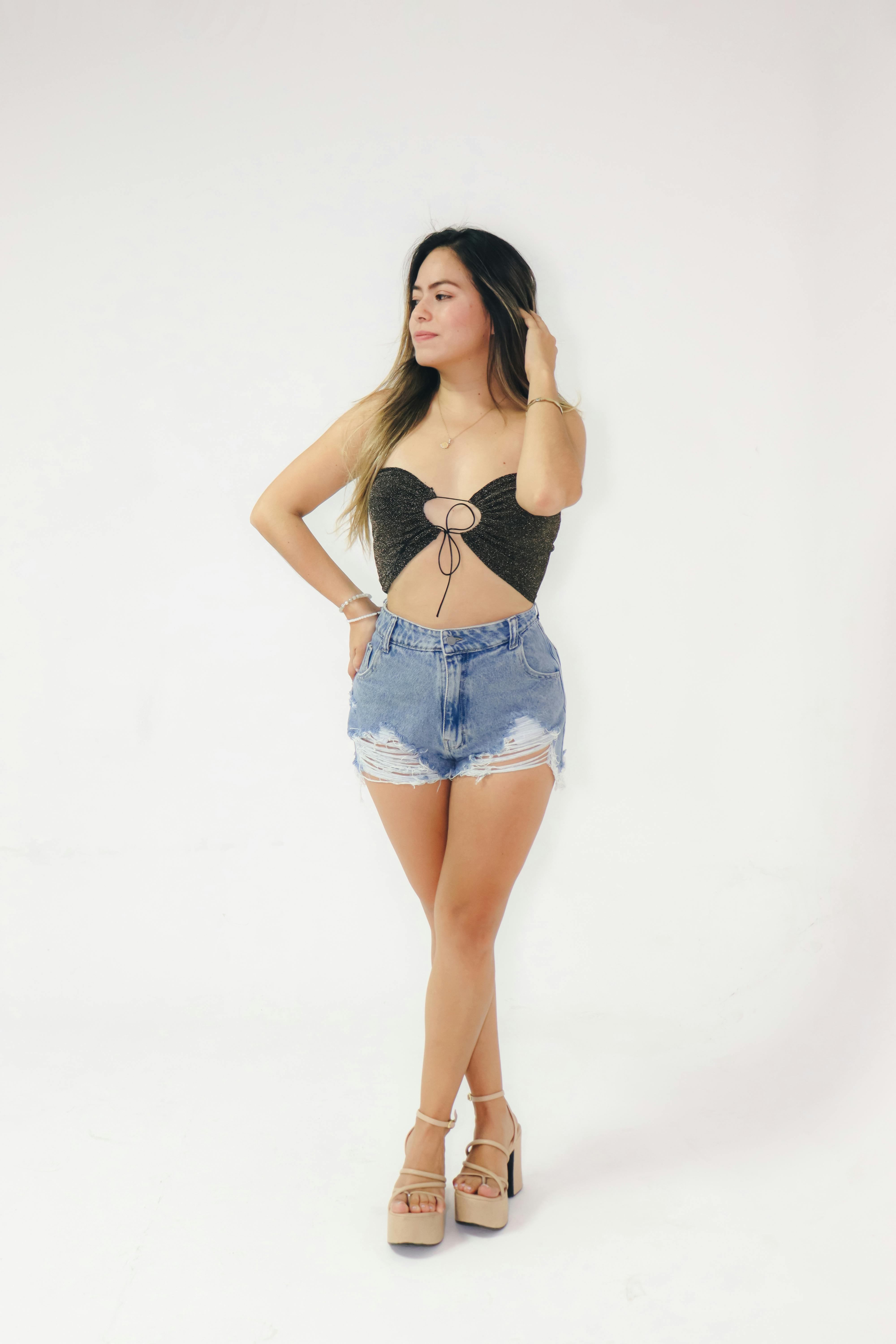 A woman in denim shorts and a bra top · Free Stock Photo