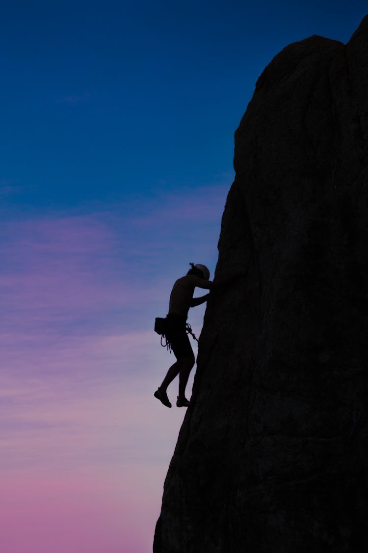 Woman Climbing Rock