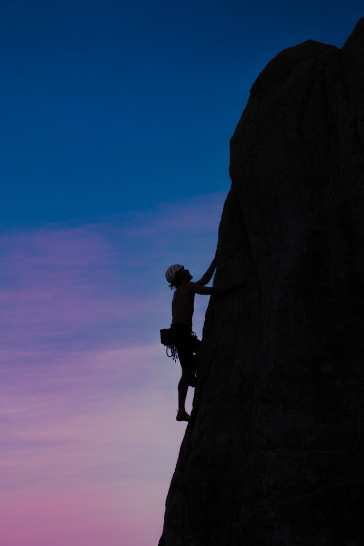 Woman Climbing Rock