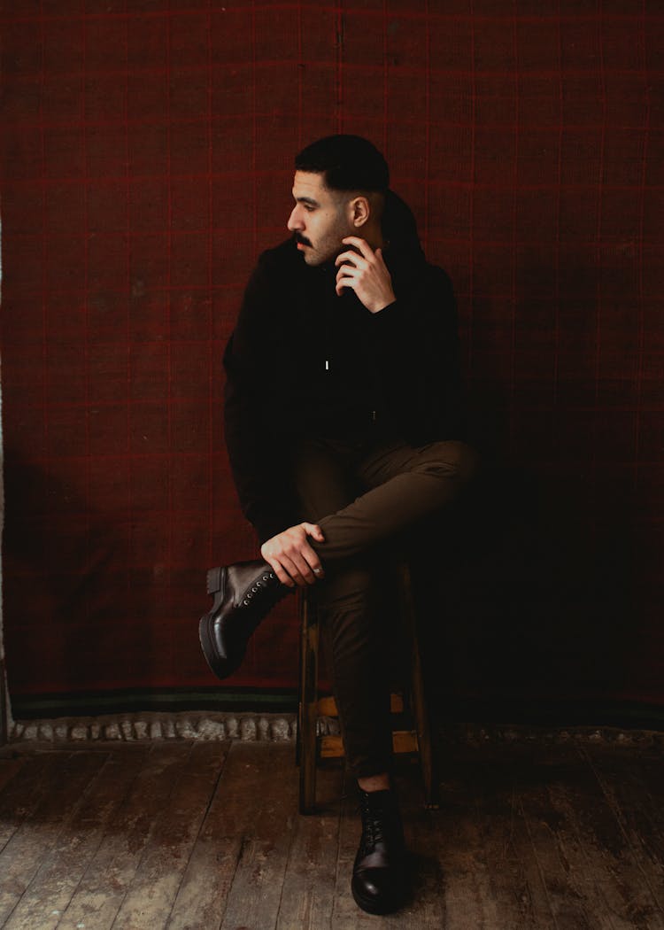 Man Sitting On Stool