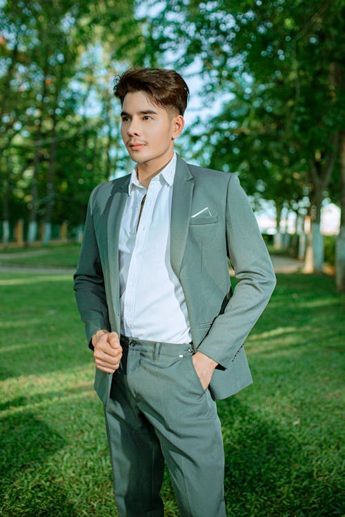 Young Elegant Man Standing in a Park 