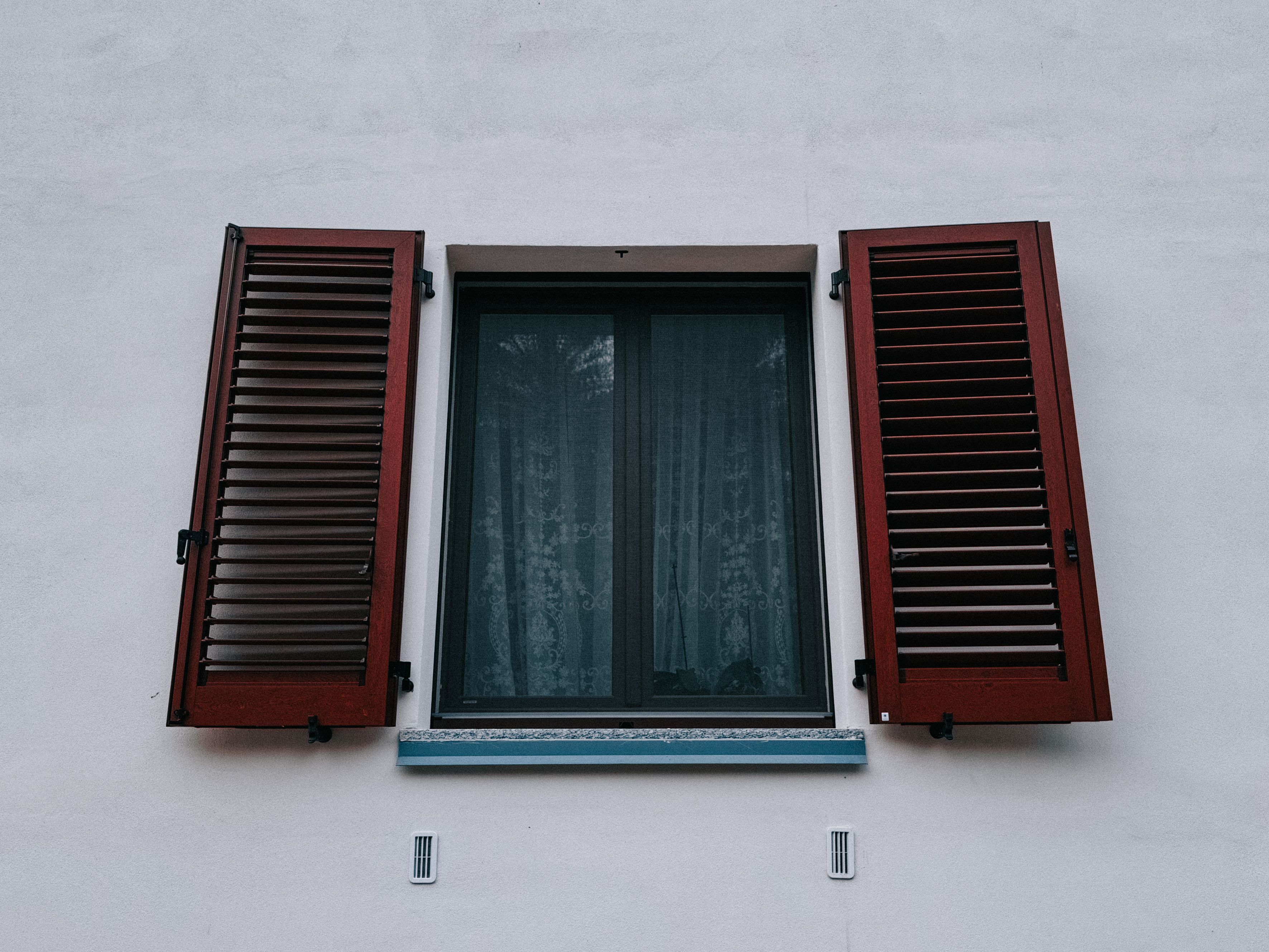 Low Angle Shot of a Window with Wooden Shutters · Free Stock Photo