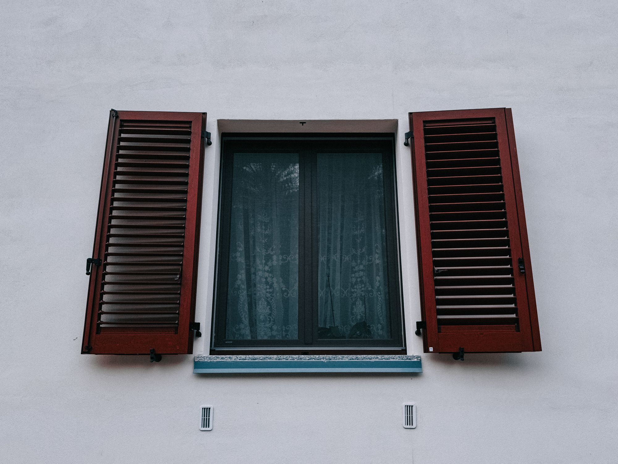 Low Angle Shot of a Window with Wooden Shutters · Free Stock Photo