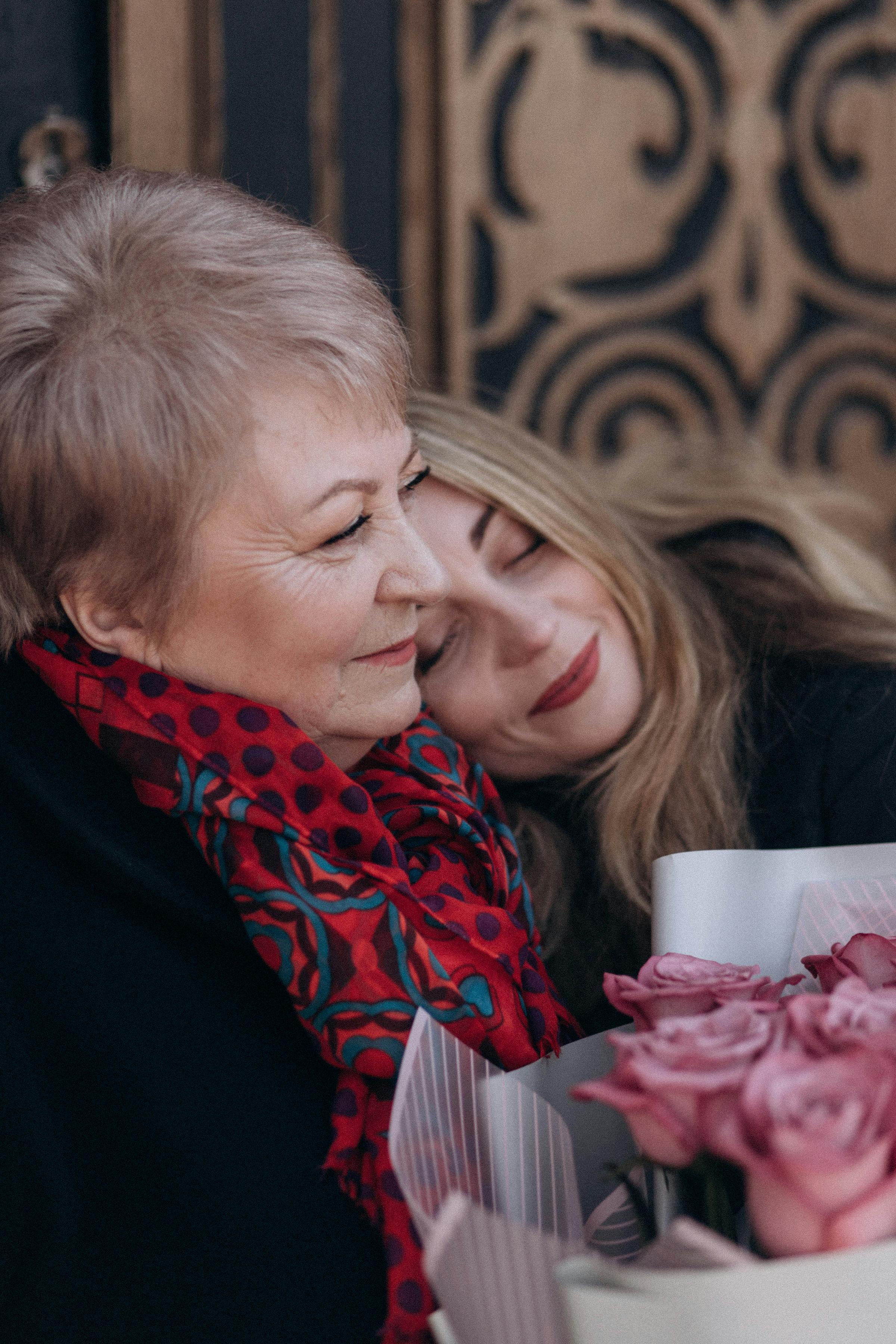 faces of smiling mother and daughter together