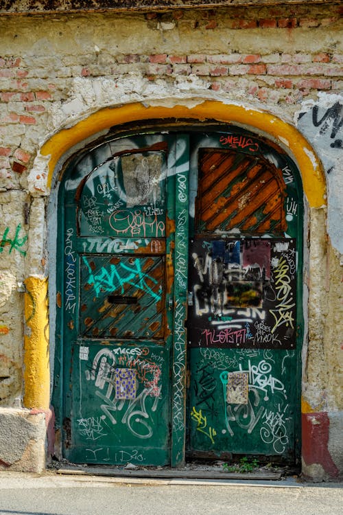 Old Door to an Abandoned Building Covered in Graffiti 
