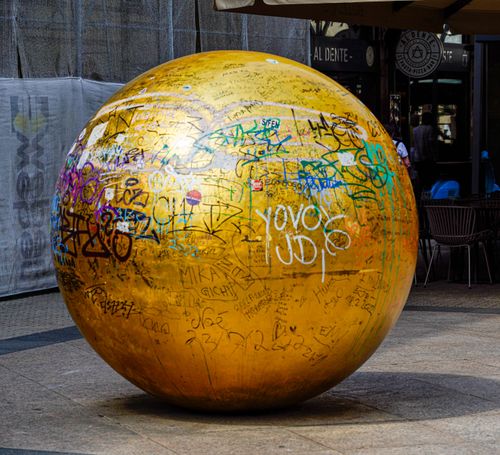 Free Golden sphere with colorful graffiti in Zagreb's city streets, capturing urban art. Stock Photo