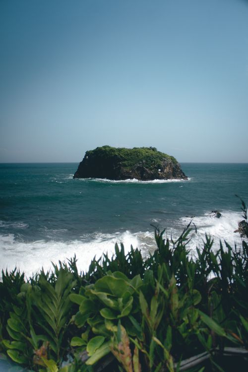 Free Beautiful view of a green island in the ocean, captured from Tasikmalaya, Indonesia coastline. Stock Photo