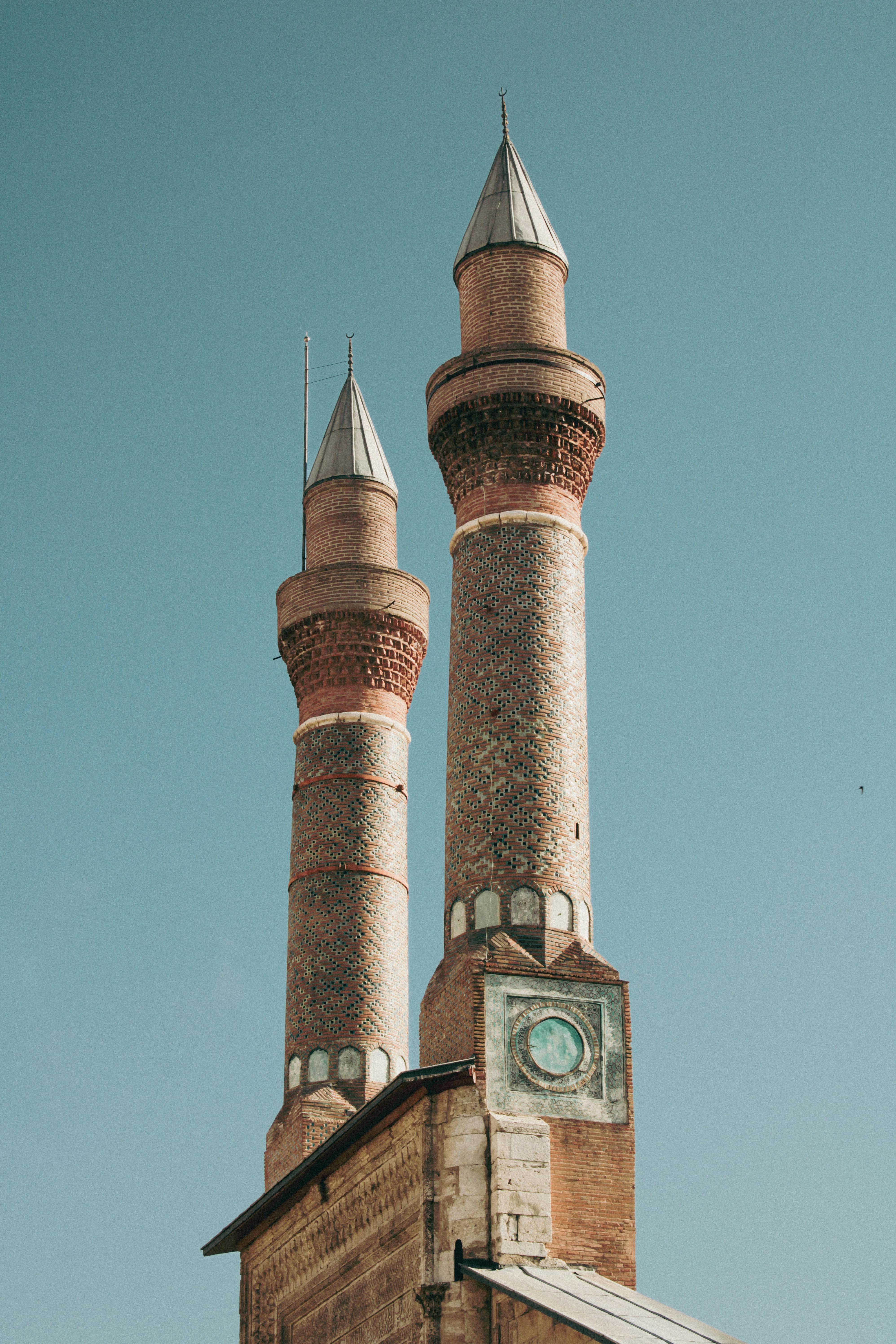 Capture of Cifte Minareli Medrese's iconic minarets against a clear blue sky in Sivas, Turkey.