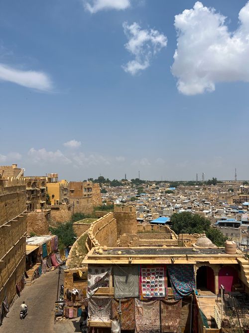 Free Aerial view of Jaisalmer's golden architecture under a vibrant sky in Rajasthan, India. Stock Photo