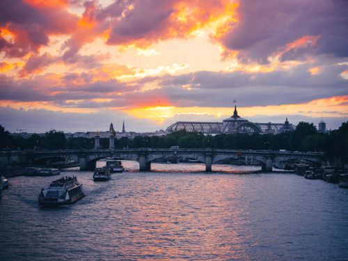 Free Beautiful sunset view of the Seine River and bridges in Paris with vibrant skies. Stock Photo