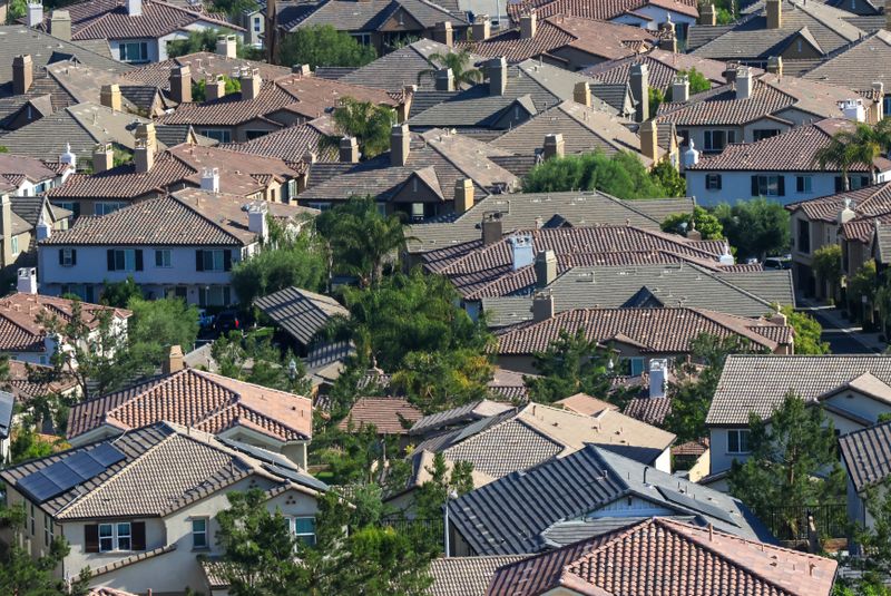 Rooftops of a dense hillside subdivision, photographed by David Brown on Pexels
