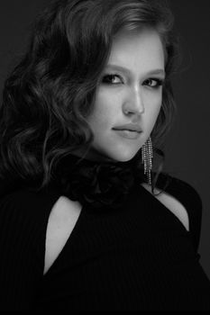 Captivating grayscale portrait of an elegant woman in a studio.