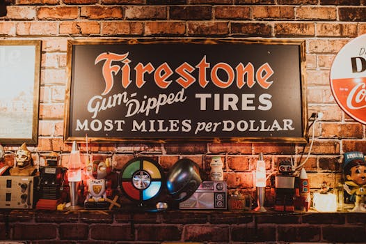 A nostalgic scene featuring a classic Firestone tire sign with vintage toys and decor against a brick wall.