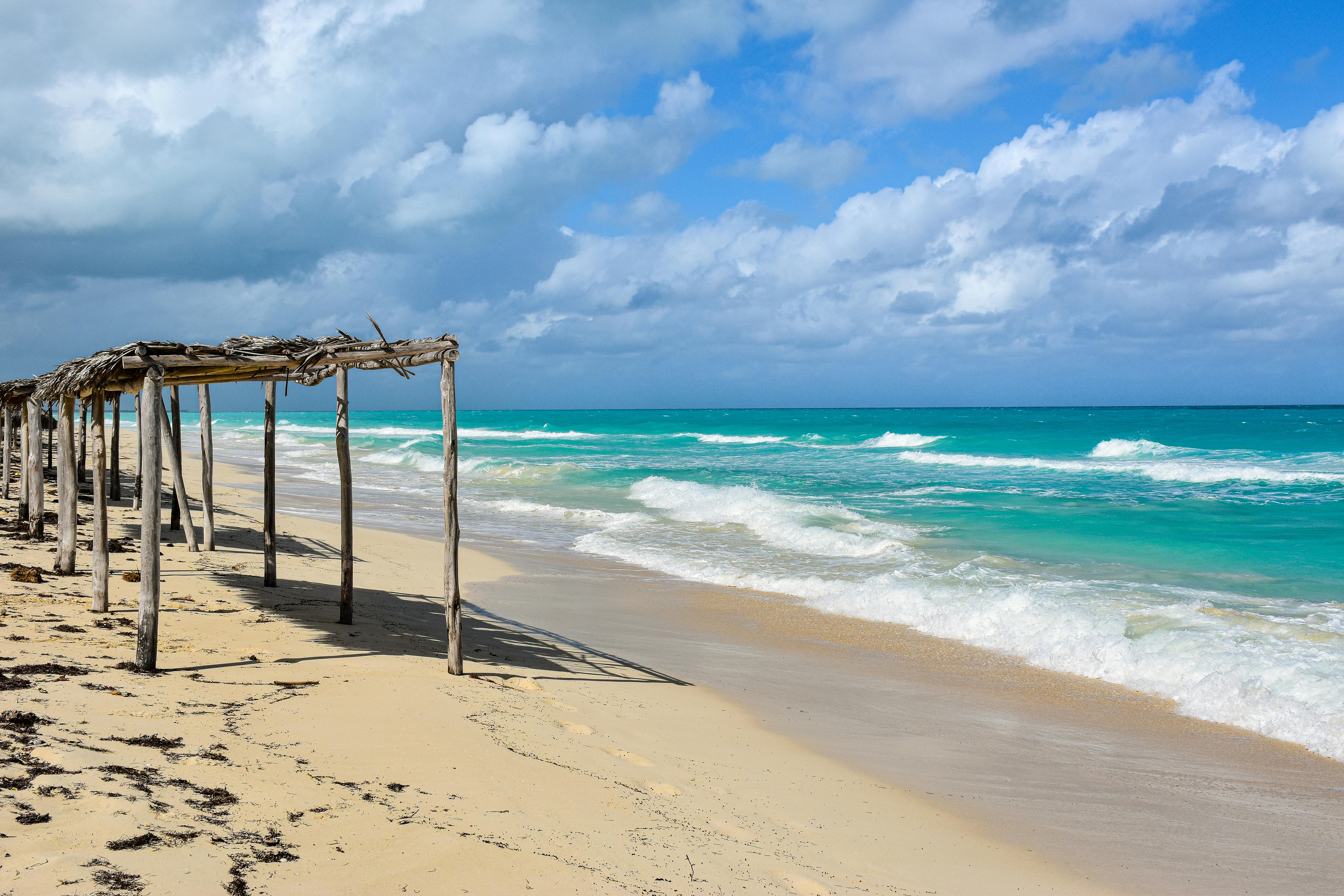 Tranquil beach scene with turquoise waves in Santa Marta, Cuba. Ideal for travel inspiration.