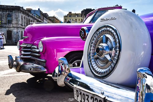Free Close-up of classic pink cars in a Cuban town, showcasing vintage charm and urban culture. Stock Photo