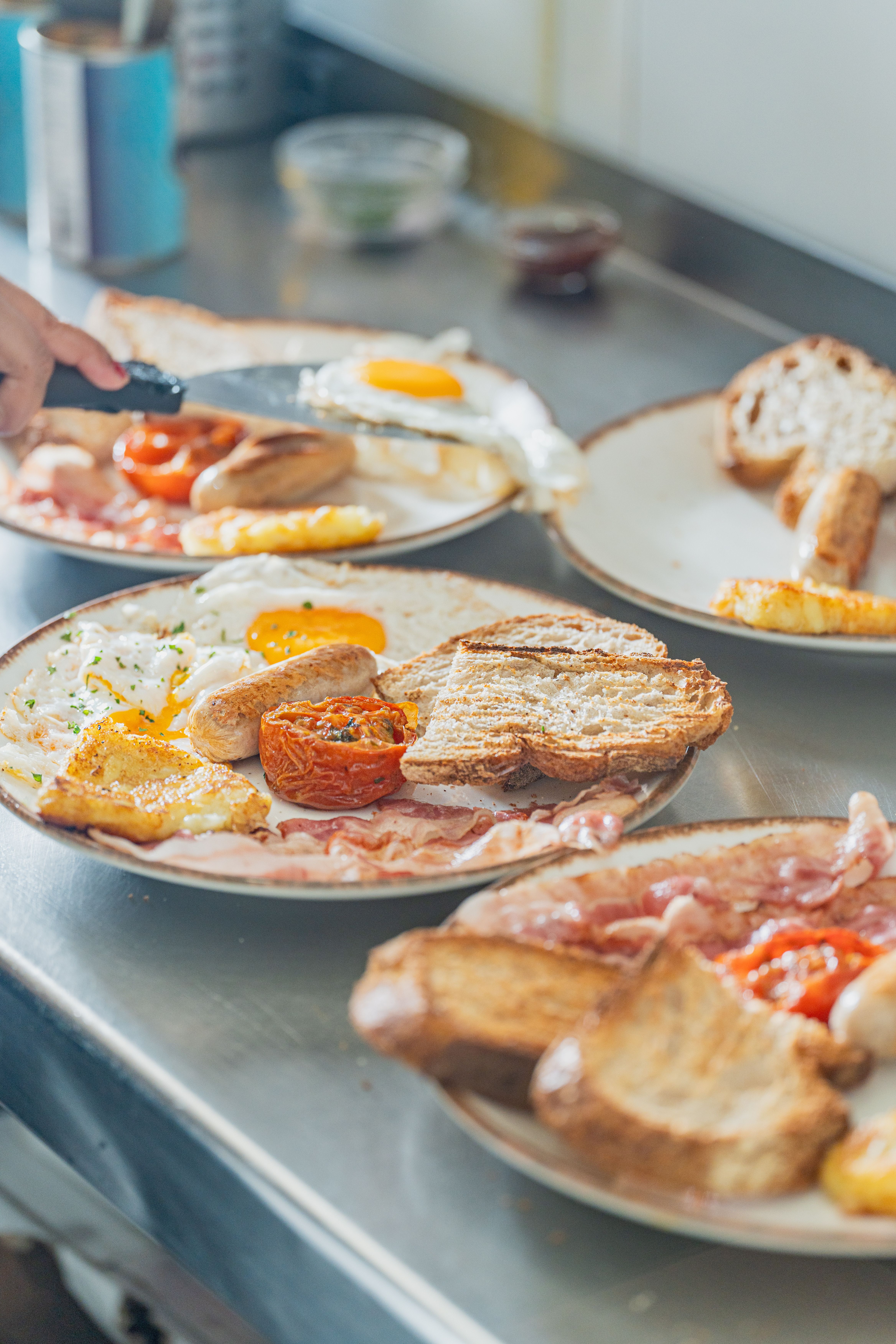 Savor a traditional English breakfast featuring eggs, bacon, sausages, and toast on a counter.