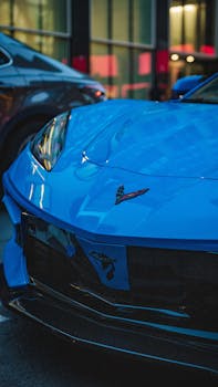 Close-up of a blue sports car in a city at night, exuding luxury and speed.
