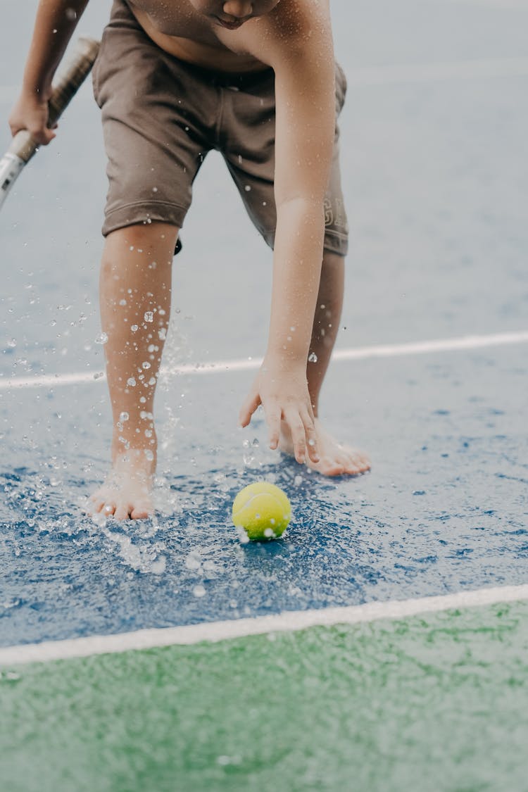 Boy Catching Tennis Ball