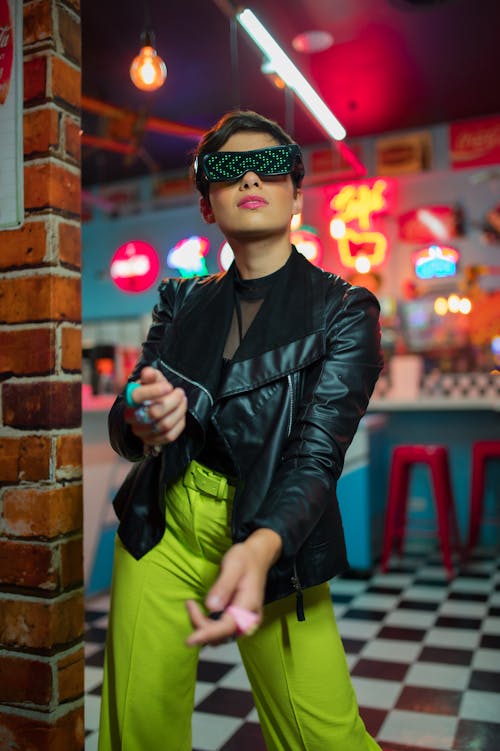Woman Posing in Sunglasses and Black Jacket