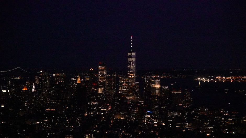 Stunning NY Helicopter Tour: Manhattan & Brooklyn Review Review 2026 - A stunning aerial view of New York City's skyline illuminated at night, showcasing iconic skyscrapers.