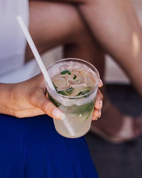 Cocktail with Straw in Woman Hand