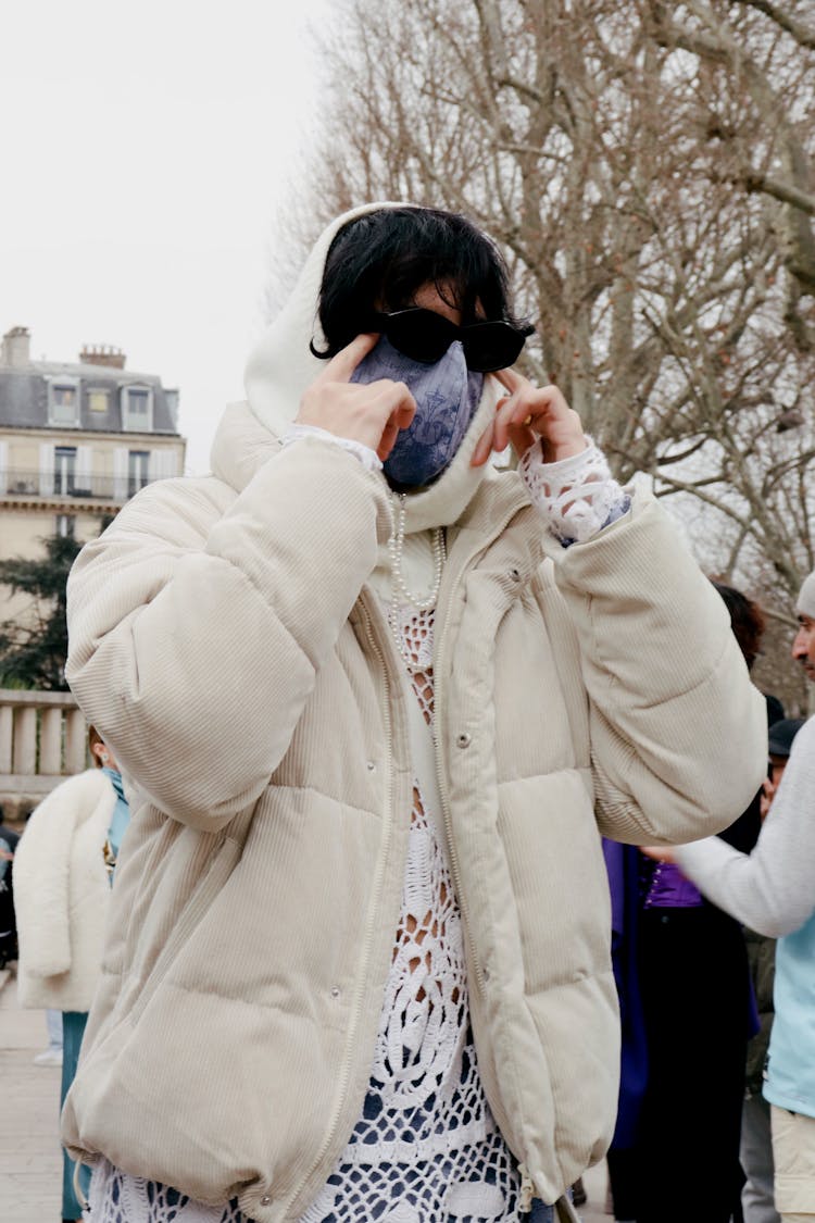 Person In White Jacket And Mask