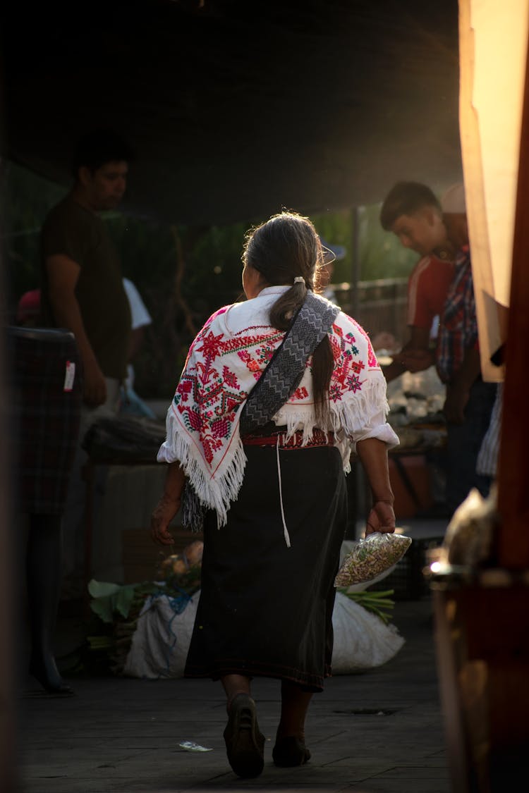 Woman In Poncho Carrying Shopping Bags