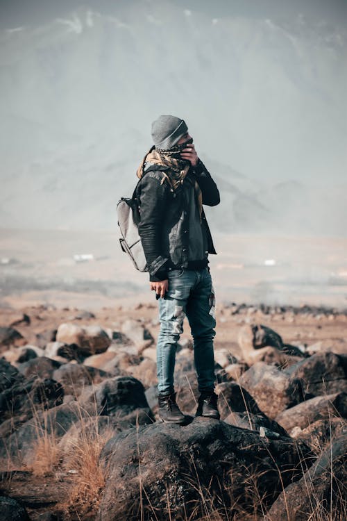 Free Man Wearing Black Jacket Standing on Gray Stone Stock Photo