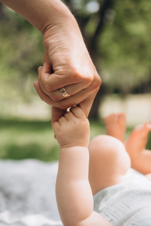 Baby Hand Holding onto its Mother Finger