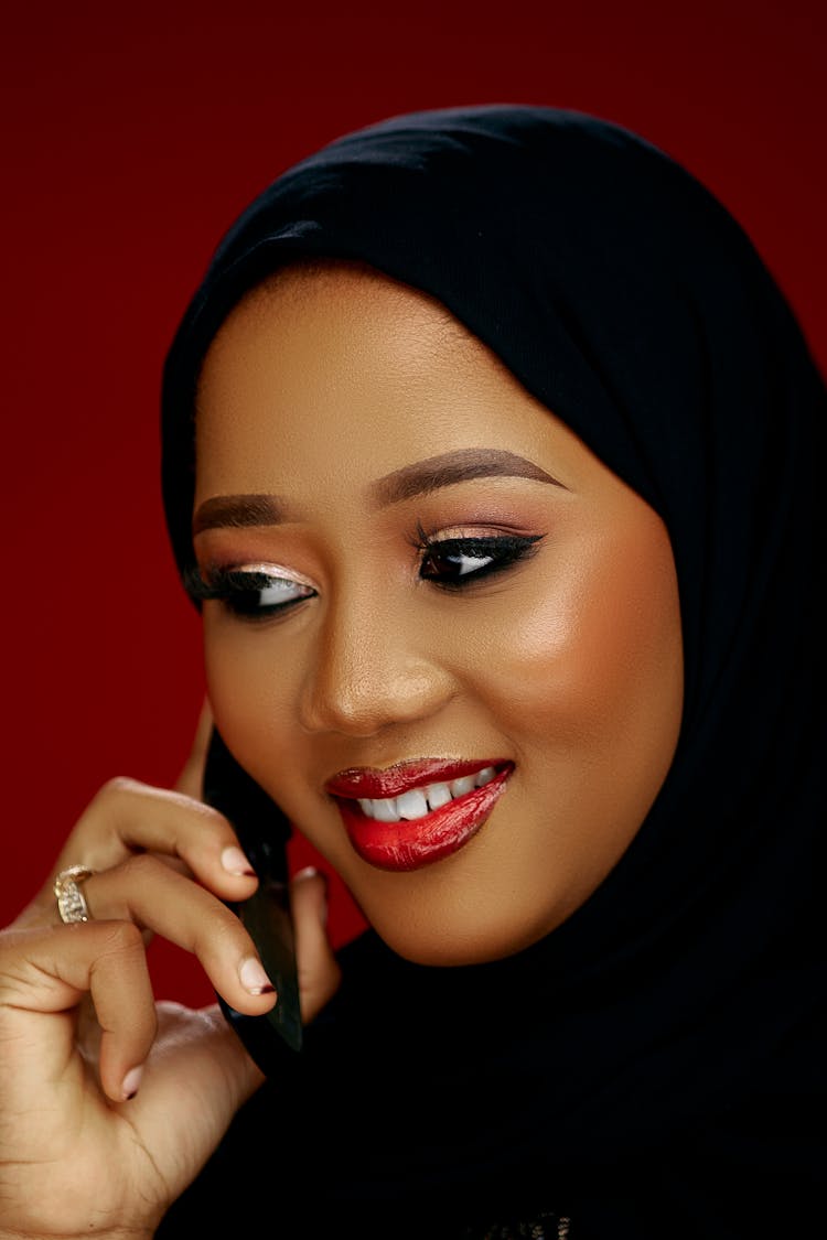 Young Woman In Black Headscarf Posing Holding A Smart Phone