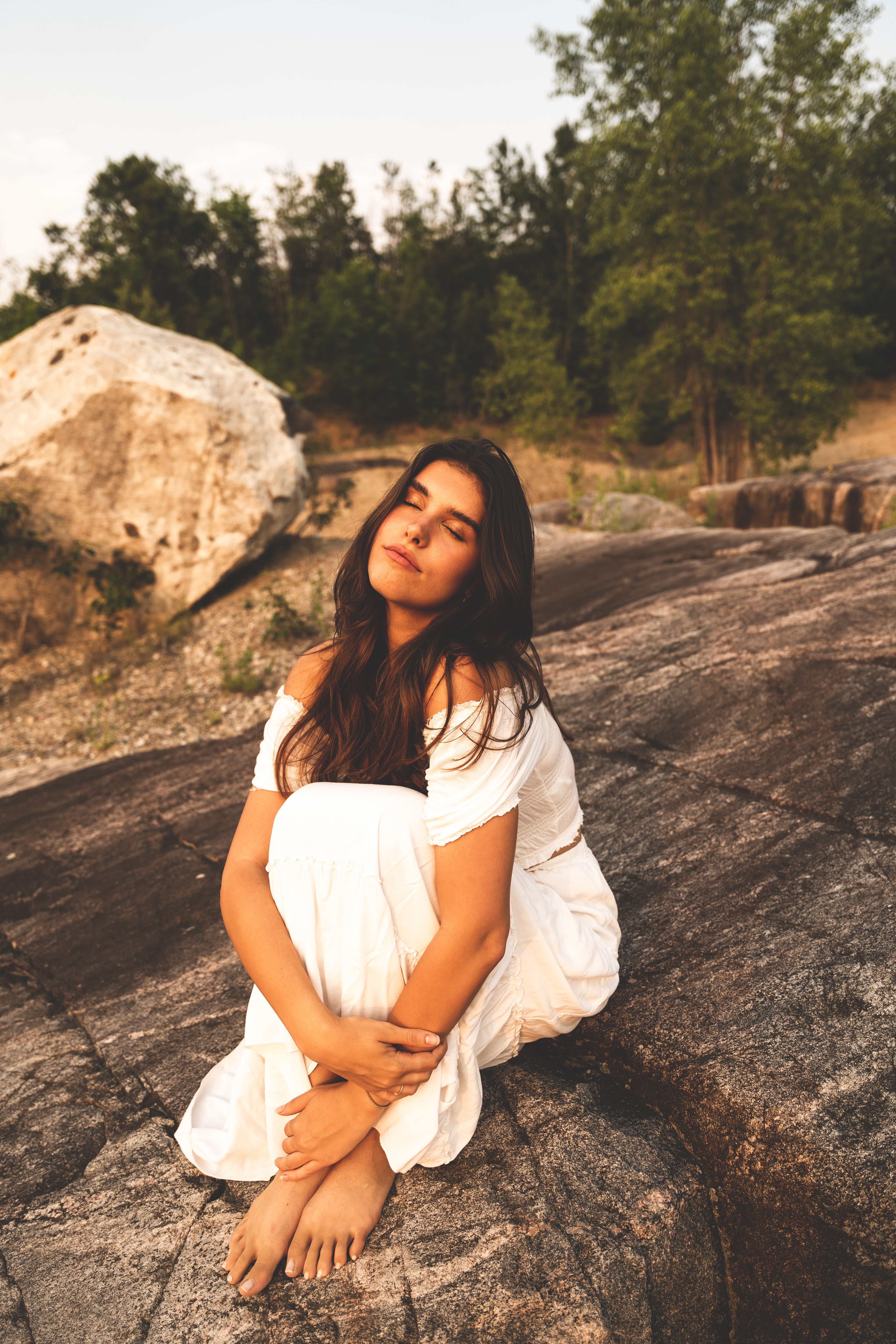 Woman in White Dress Sitting on Rock · Free Stock Photo