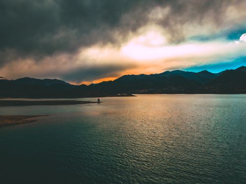 Free Stunning sunset view over Potrerillos Reservoir with dramatic clouds and mountains in Mendoza, Argentina. Stock Photo
