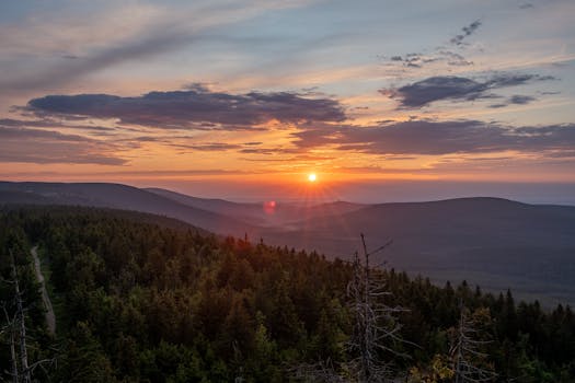 Captivating view of sunset over Szklarska Poręba forested mountains.