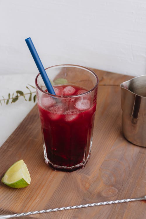 Glass of Red Fruit Lemonade on a Wooden Table