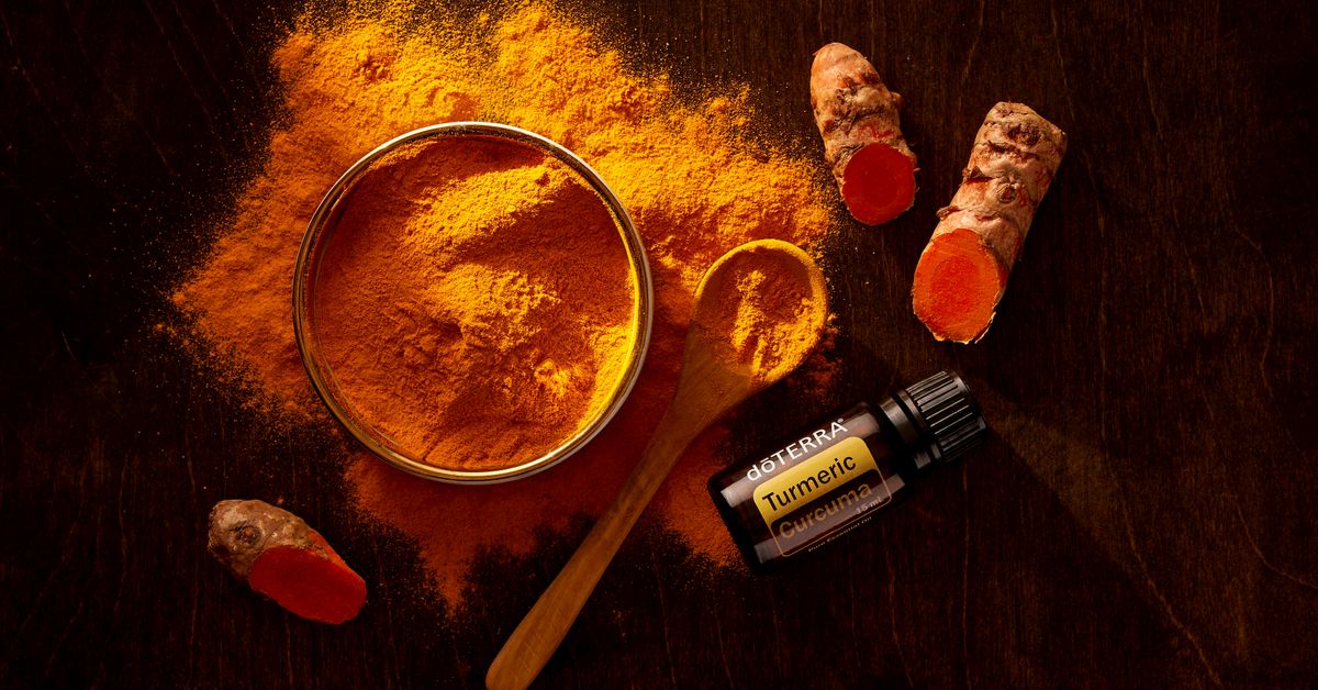Turmeric root and powder on a surface