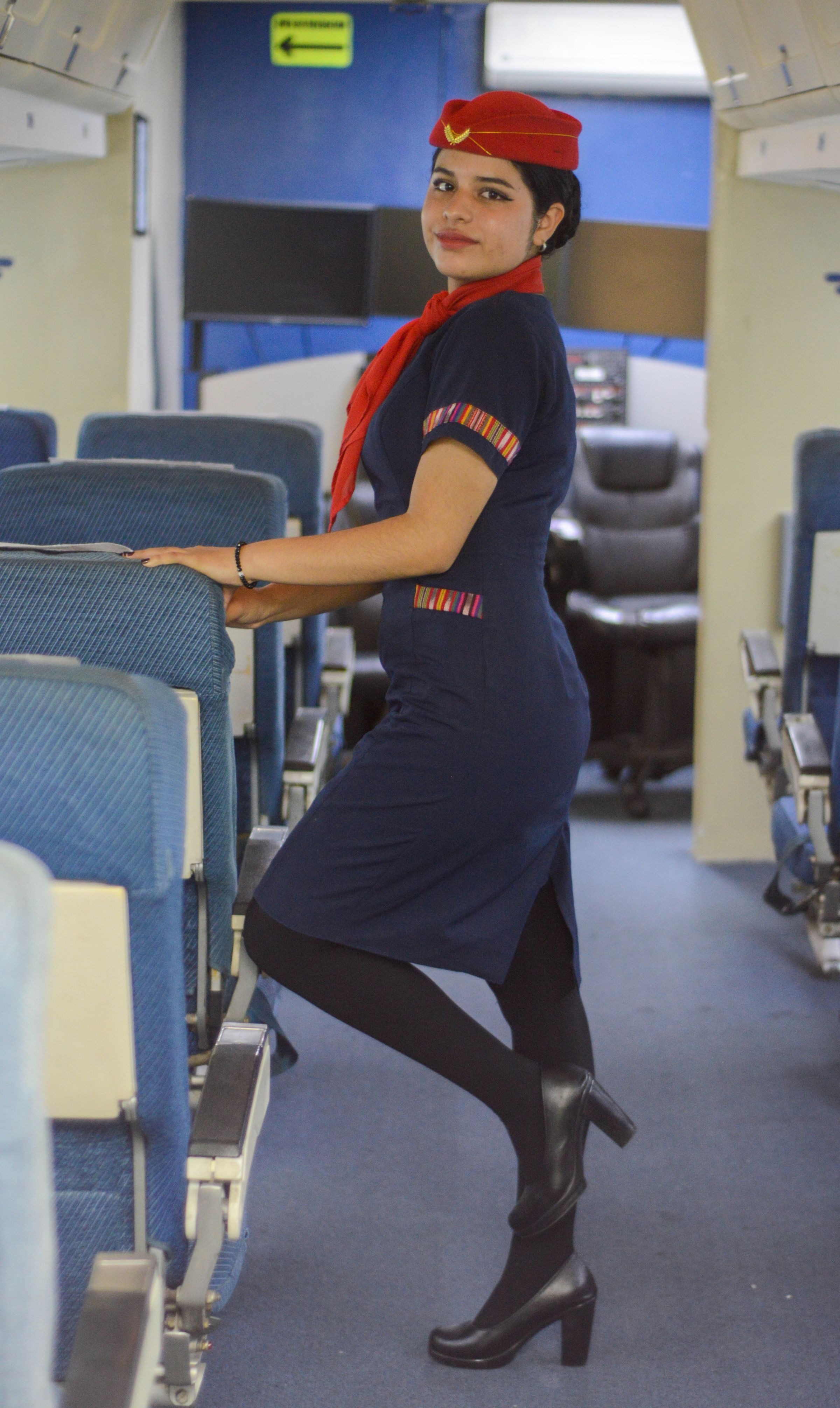 Professional flight attendant in aircraft cabin