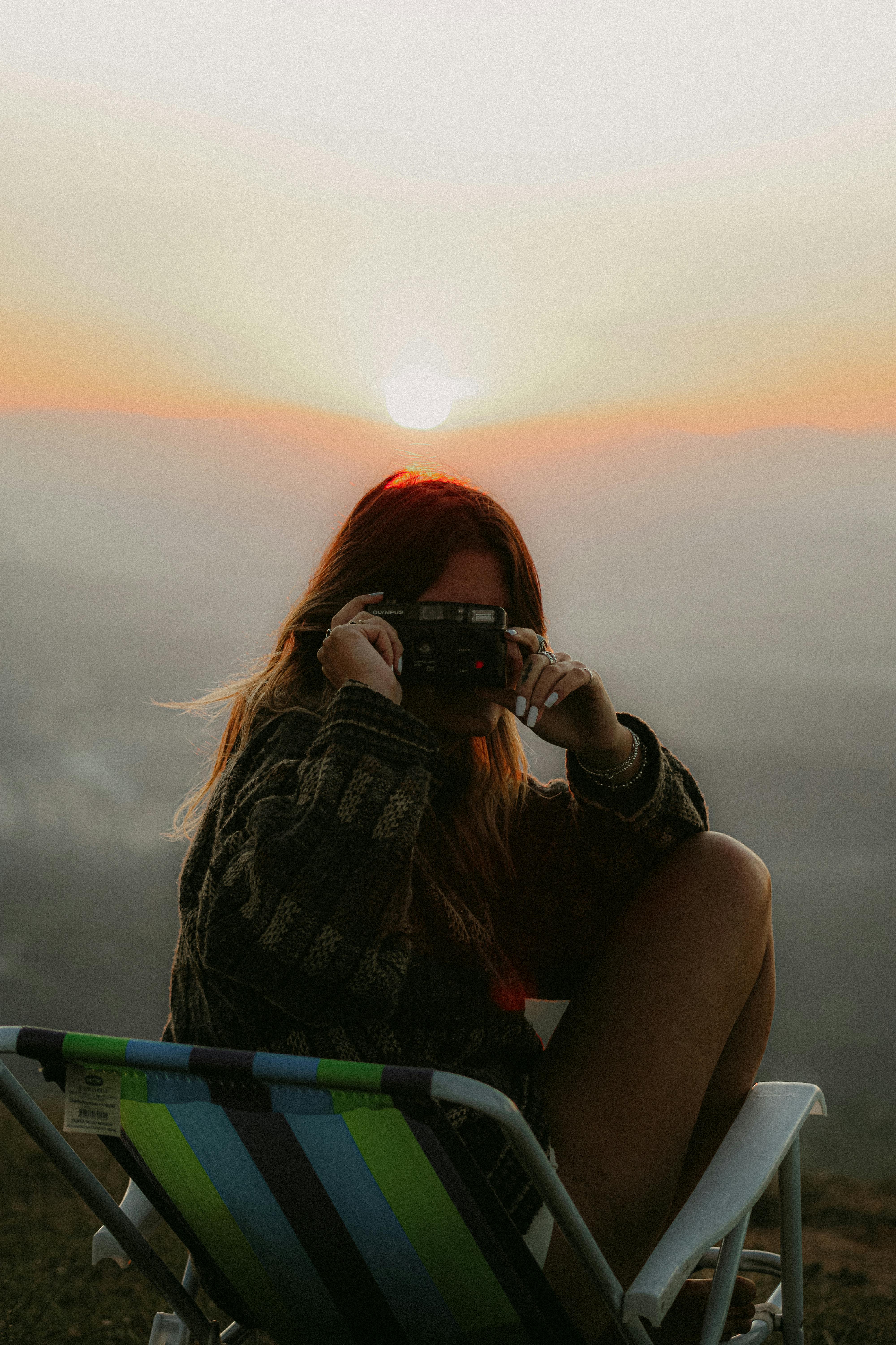 Premium Photo | Young woman holding sun on hands meditating near the sea