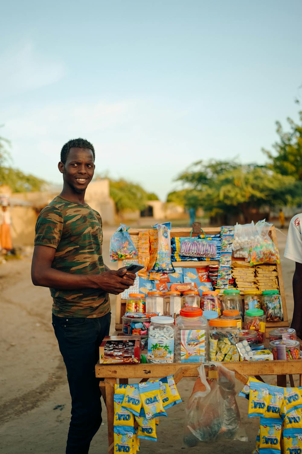A Man Selling Snacks at the Stall Outside · Free Stock Photo