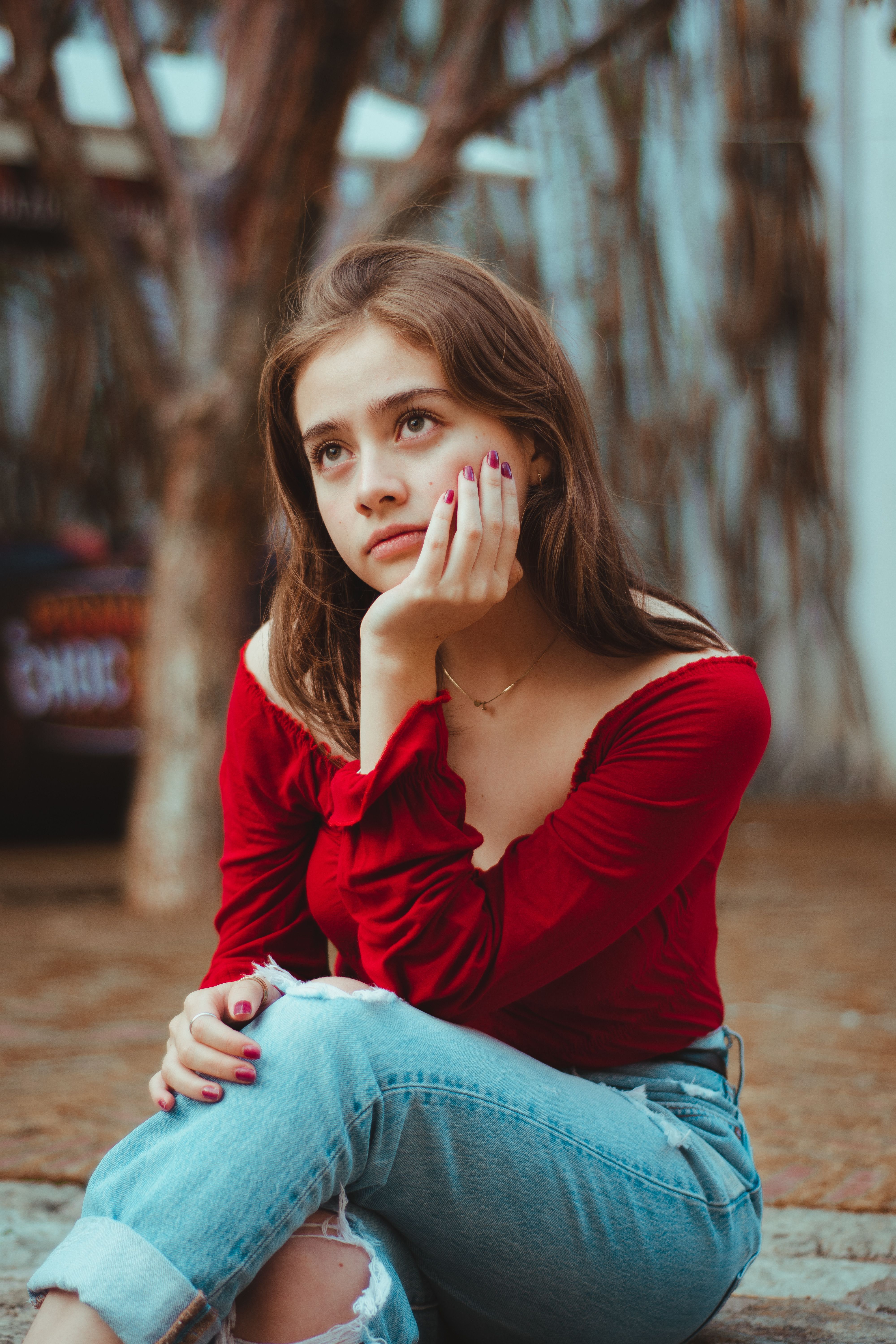 Woman in jeans with red cardigan
