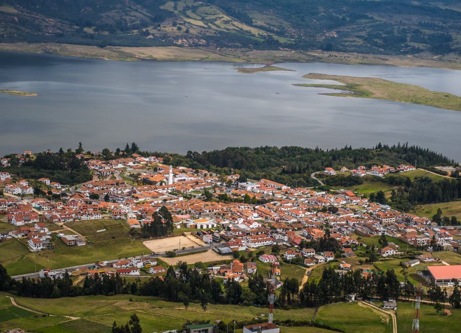 Stunning aerial view of Guatavita town and Tomine Reservoir in Colombia, showcasing a peaceful landscape.