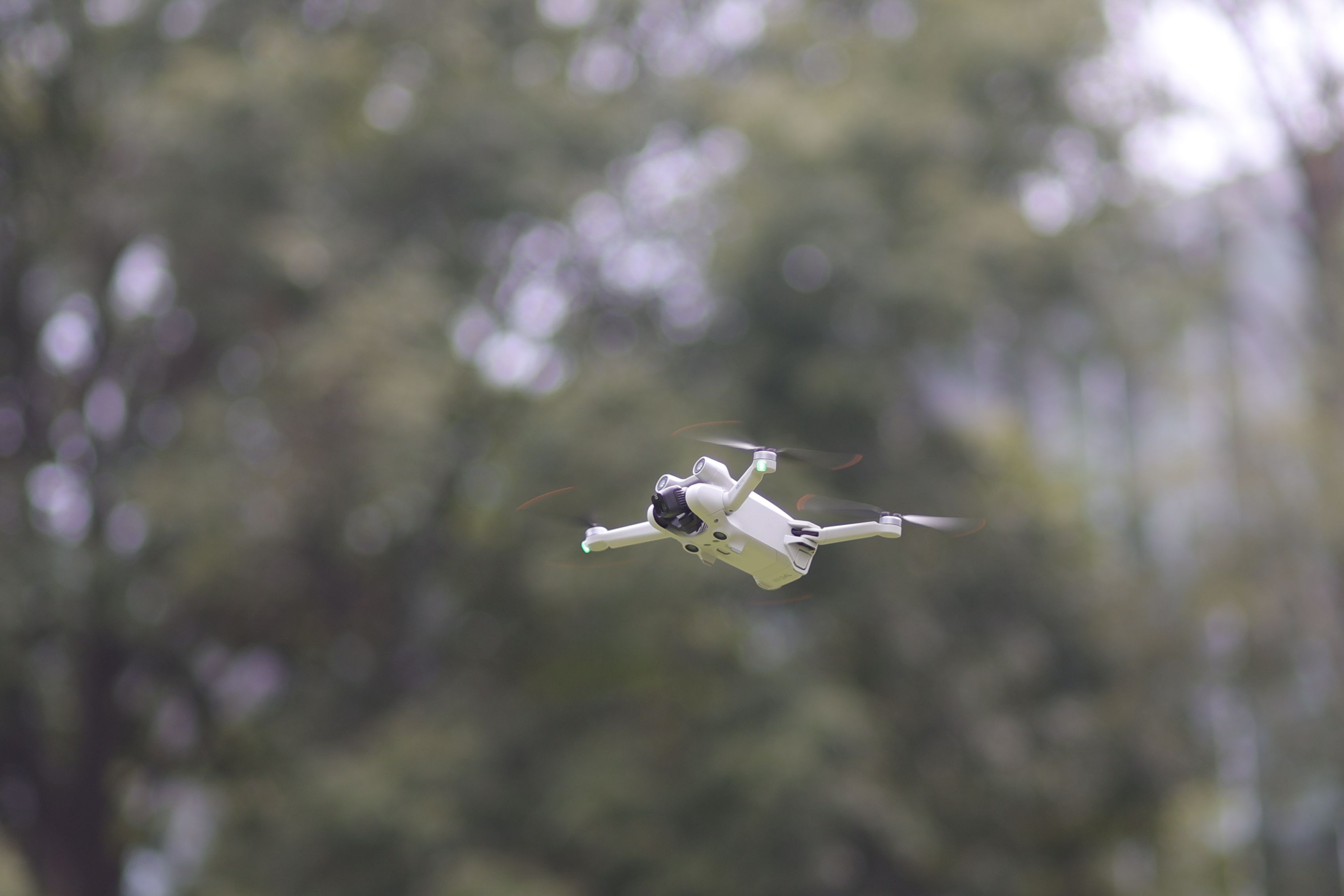 A cutting-edge drone flying outdoors, focused on advanced technology and aerial photography.