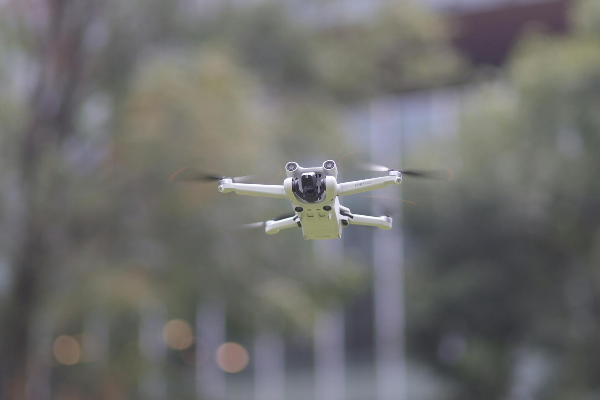 Close-up of a quadcopter drone flying outdoors, showcasing modern technology.