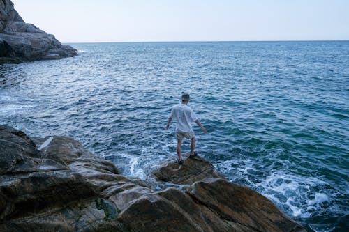 A Man Standing by a Sea 