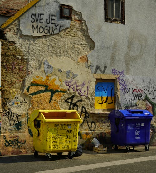 Tags on Wall and Garbage Bins in Alley in Town